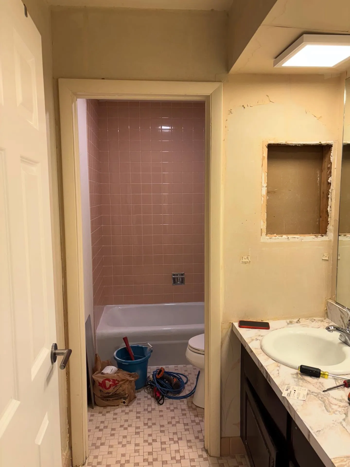1960s bath, day one — original tile coming out