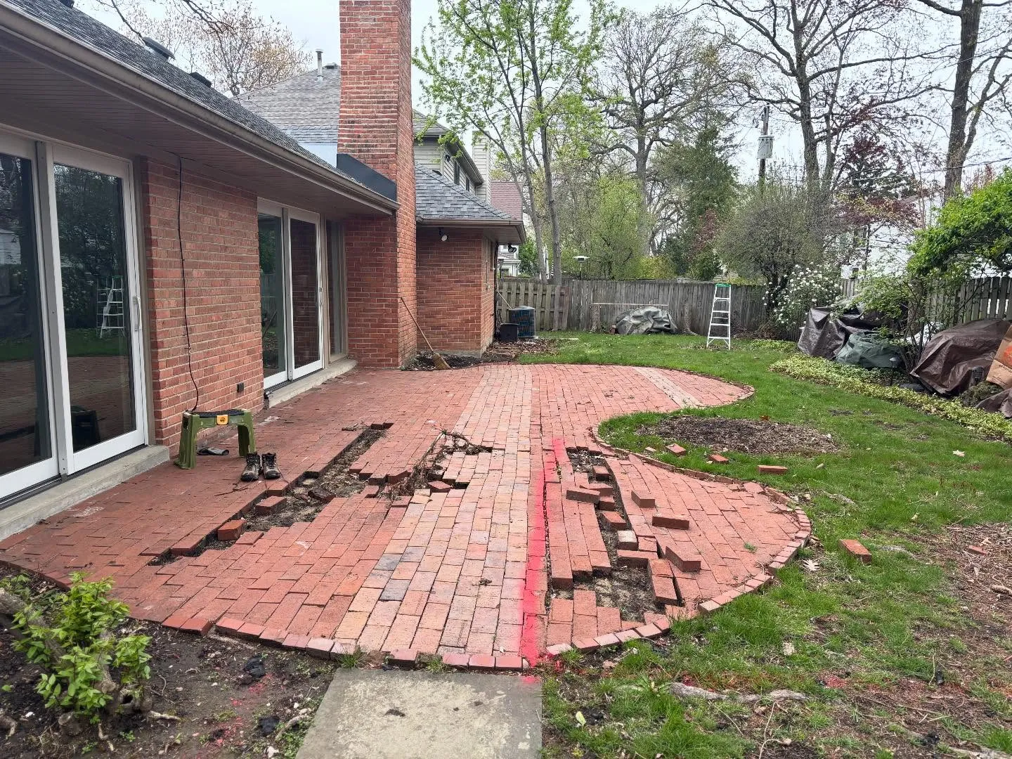 Brick patio releveling — lifting settled pavers and resetting the field