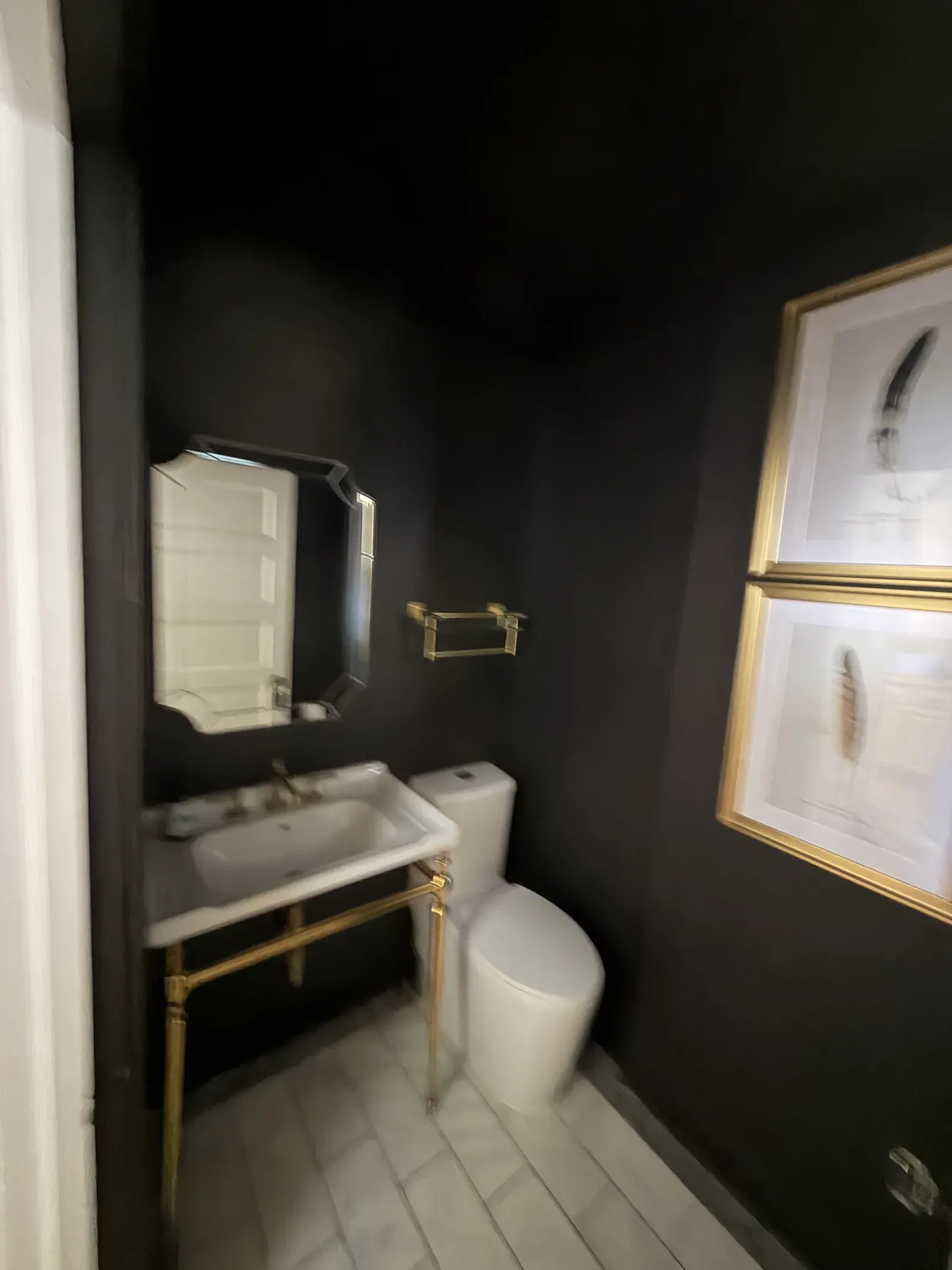 Powder room — console sink with brass legs, marble basketweave floor