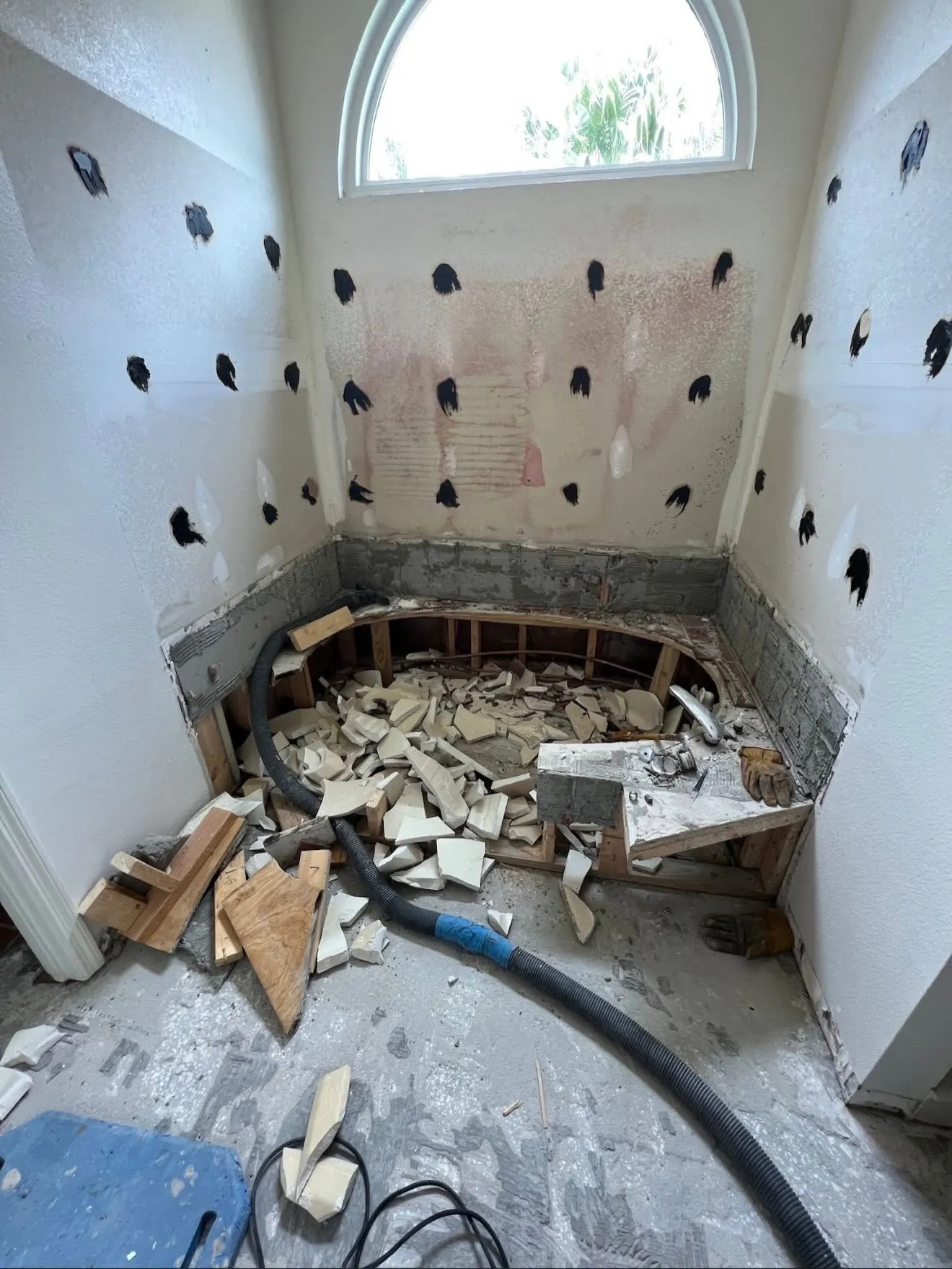 Garden-tub demo — down to the studs before a walk-in shower conversion